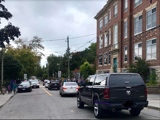 Residents and children on the morning walk to school at Hopewell Ave on crowded sidewalks and crosswalks.