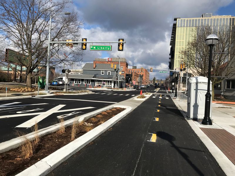 Picture shows a bidirectional bicycle lane with a pedestrian crossover in the distance. 