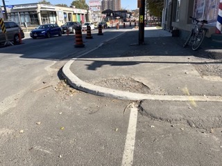Picture of a curb cut needing some work.