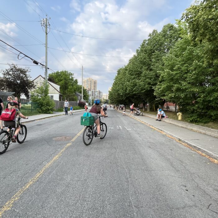 Image of children and parents biking or walking on a temporary school street