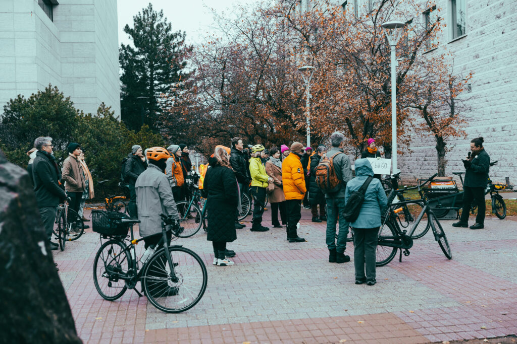 Crowd listening to a speaker at the bill 60 rally. Some are with their bikes.